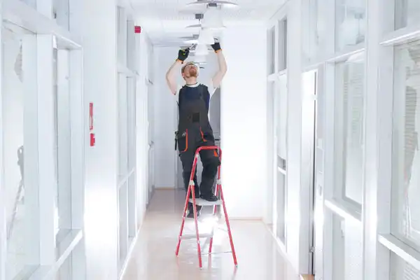 One Man Working on a Ceiling Lighting System